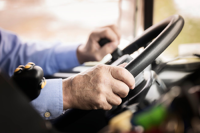 Driver operating a collection truck